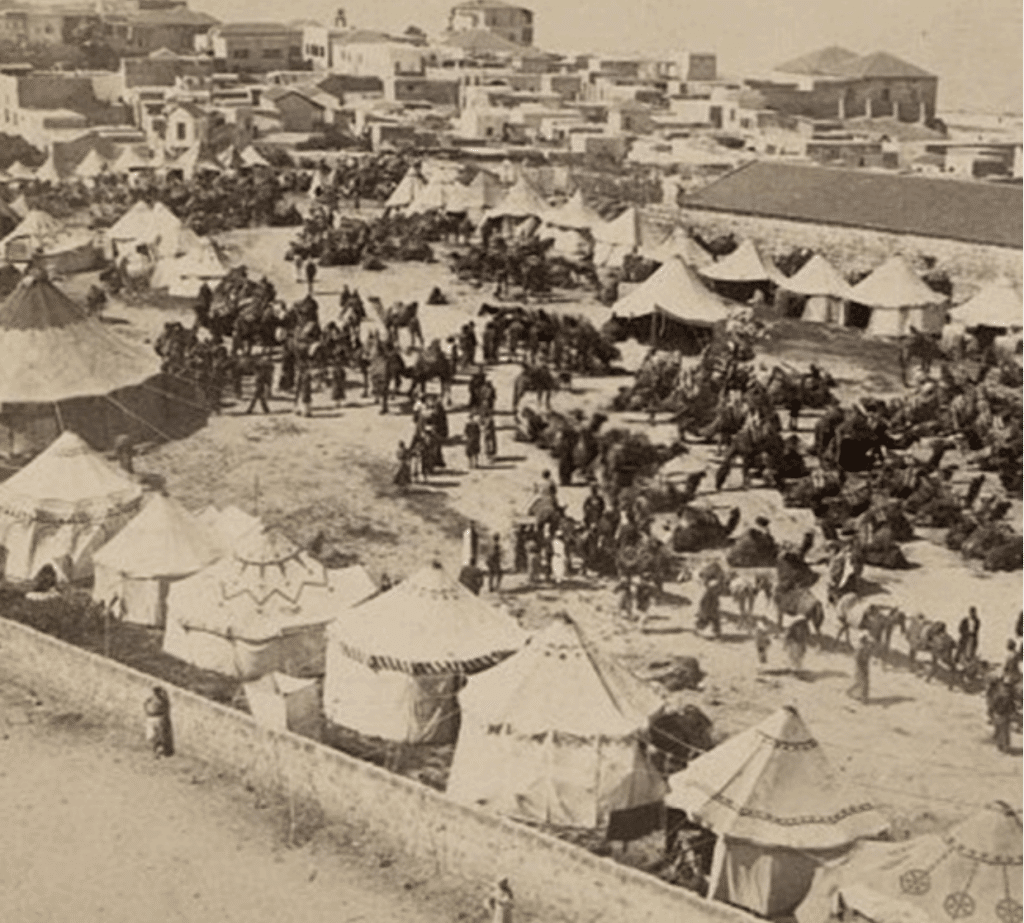 A caravan of Persian pilgrims in Jaffa, Palestine on their journey to Mecca, c. 1900.
